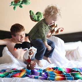 Children playing on the bed