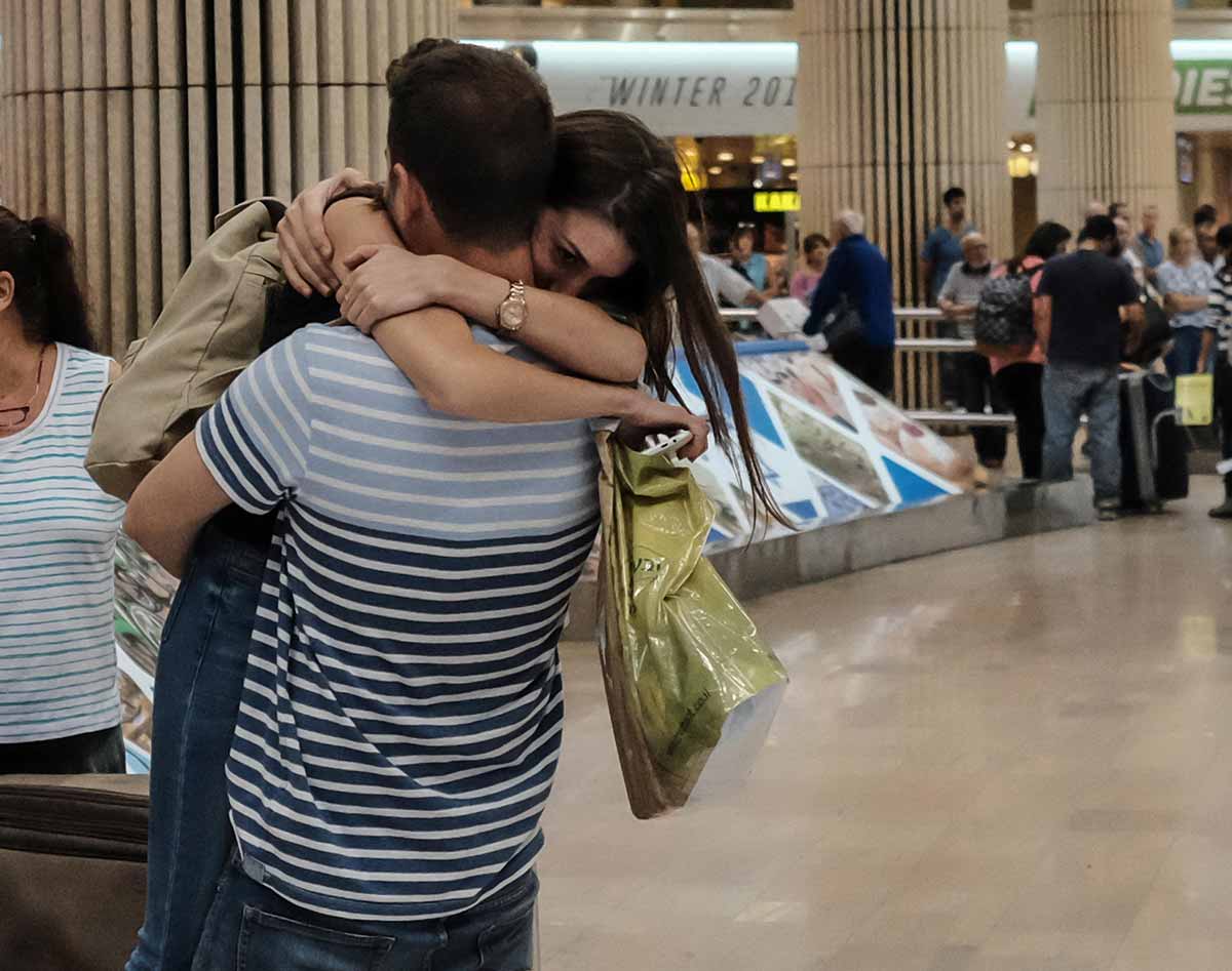 Young couple embracing each other at Airport