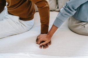 Couple sitting on bed body language shows upset